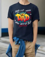 King Dad Attributes Tee Strong Loving Father’s Day T-Shirt Gift for Papa - model wearing navy shirt, hands in pockets