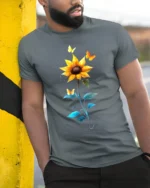 Sunflower Butterfly Tee Vibrant Floral Insect T-Shirt for Nature Lovers - model in grey shirt leaning against column