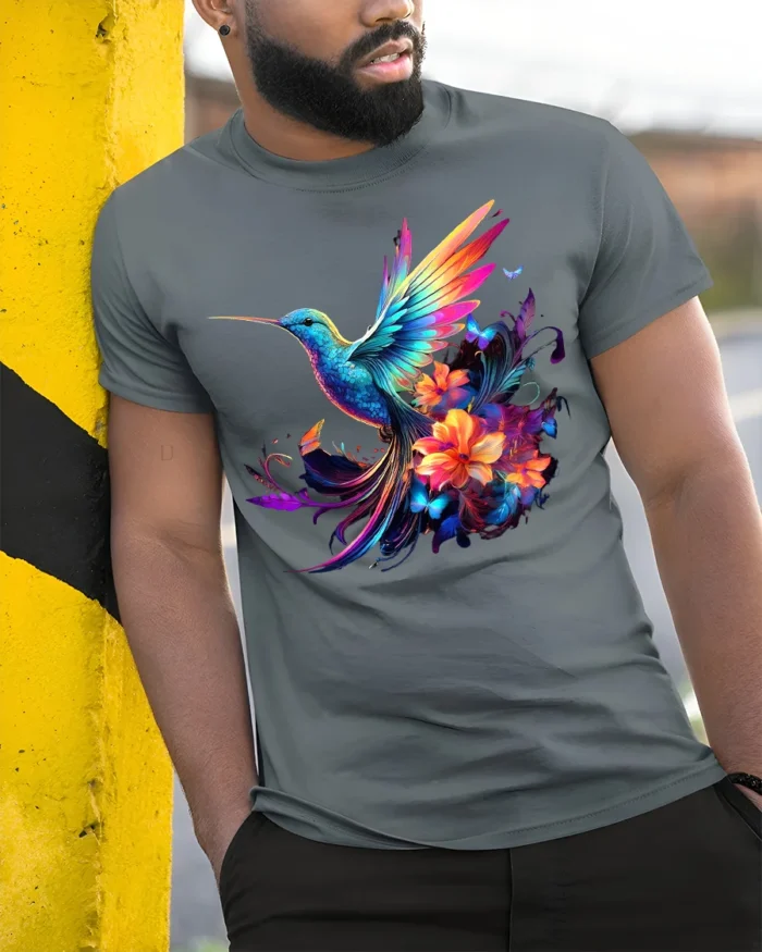 Rainbow Hummingbird Tee Vibrant Floral Butterfly T-Shirt for Nature Lovers - model in grey shirt leaning against column