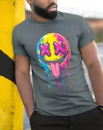 Melting Smiley Face Tee Colorful Dripping Emoji T-Shirt for Fun Style - model in grey shirt leaning against column