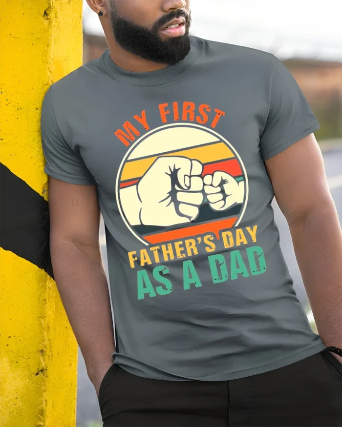 First Father’s Day Fist Bump Tee New Dad T-Shirt for Proud Fathers - model in grey shirt leaning against column