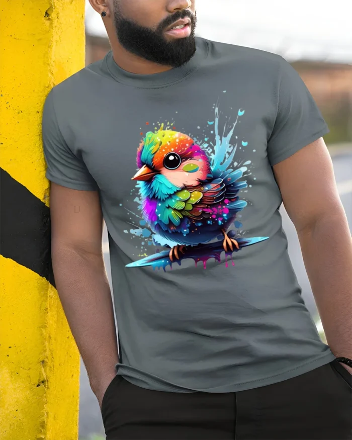 Cute Rainbow Bird Colorful Splash Art Tee for Animal and Nature Lovers - model in grey shirt leaning against column