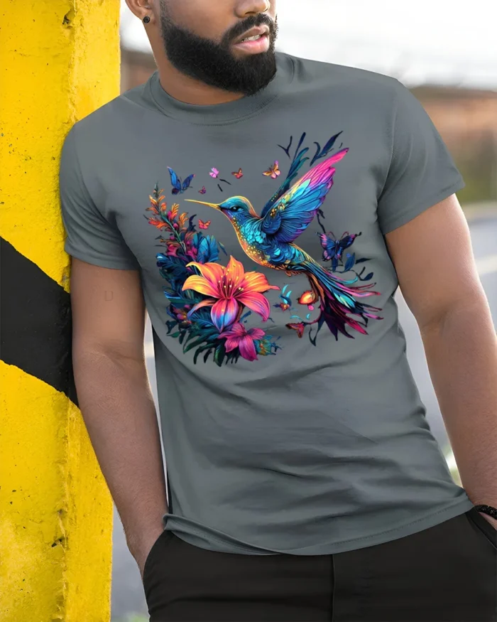 Nature Art Hummingbird T-Shirt Bright Floral Print Tee with Butterflies - model in grey shirt leaning against column