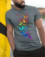 Rainbow Wings Colorful Flying Butterflies T-Shirt for Nature Fans - model in grey shirt leaning against column