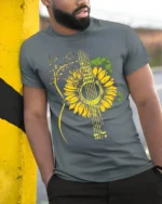 Sunflower Guitar T-Shirt Floral Musical Notes Tee for Music and Nature Lovers - model in grey shirt leaning against column