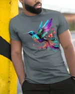 Vibrant Rainbow Hummingbird T-Shirt  Artistic Floral Bird Tee for Nature Fans - model in grey shirt leaning against column