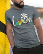 Rainbow Flower Love T-Shirt Soft Cotton Inspirational Graphic Tee - model in grey shirt leaning against column