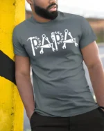 Papa Fix-It T-Shirt Tools Design Gift for Handy Dads - model in grey shirt leaning against column