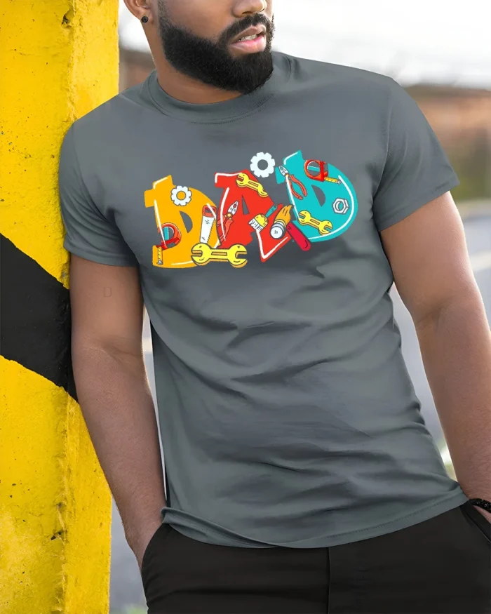 Colorful Dad T-Shirt with Tools Fun Father’s Day Gift Tee - model in grey shirt leaning against column