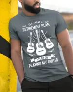 Retirement Plan Playing My Guitar T-Shirt Music Lover - model in grey shirt leaning against column