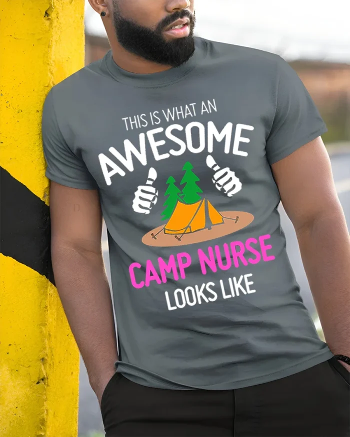 Awesome Camp Nurse T-Shirt Funny Outdoor Camping Tee - model in grey shirt leaning against column