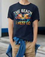 The Beach Is Calling T-Shirt Retro Summer Vacation Tee - model wearing navy shirt, hands in pockets