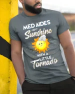 Funny Med Aides T-Shirt Sunshine and Tornado Design Tee - model in grey shirt leaning against column