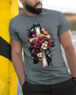 Floral Cross T-Shirt Artistic Faith Design on Soft Tee - model in grey shirt leaning against column
