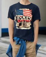 USA Flag Dad T-Shirt with Combat Boots Veteran Tribute - model wearing navy shirt, hands in pockets