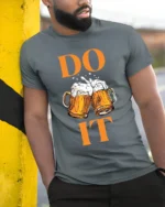 Funny Beer T-Shirt DO IT Beer Mugs Cheers Graphic - model in grey shirt leaning against column