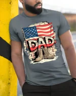 USA Flag Dad T-Shirt with Combat Boots Veteran Tribute - model in grey shirt leaning against column