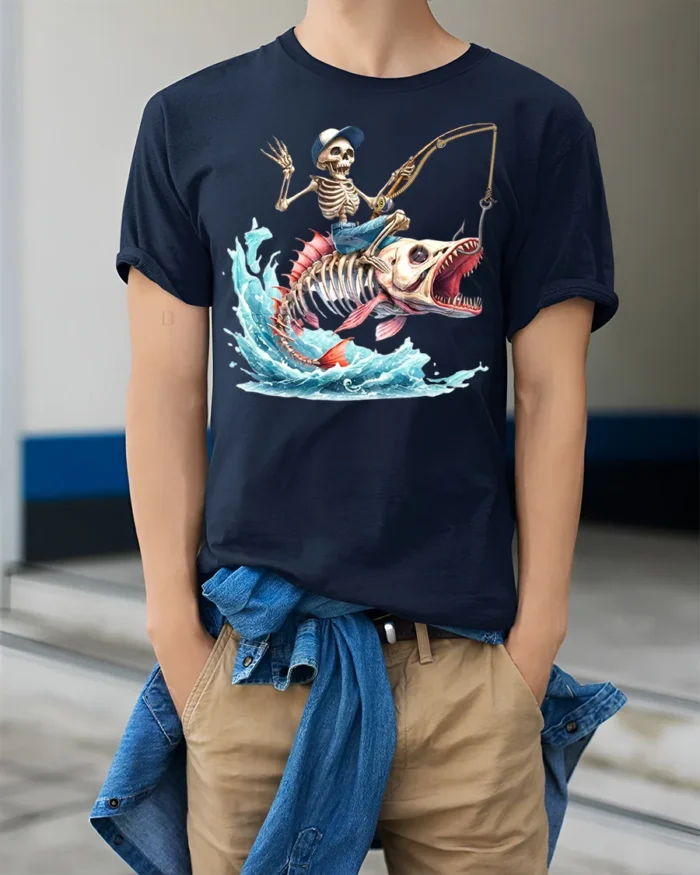 Skeleton Fisherman Monster Fish T-Shirt Funny Graphic - model wearing navy shirt, hands in pockets