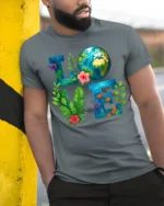 Earth Love T-Shirt Eco Nature Inspired Graphic Tee - model in grey shirt leaning against column