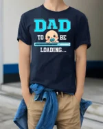 Dad To Be Loading Funny Pregnancy T-Shirt - model wearing navy shirt, hands in pockets