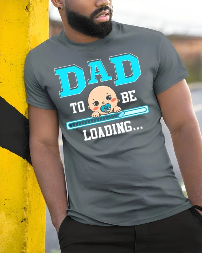 Dad To Be Loading Funny Pregnancy T-Shirt - model in grey shirt leaning against column