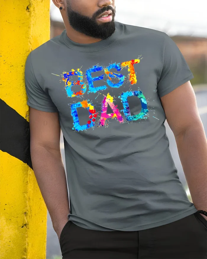 Best Dad Splatter Colorful Father’s Day T-Shirt - model in grey shirt leaning against column