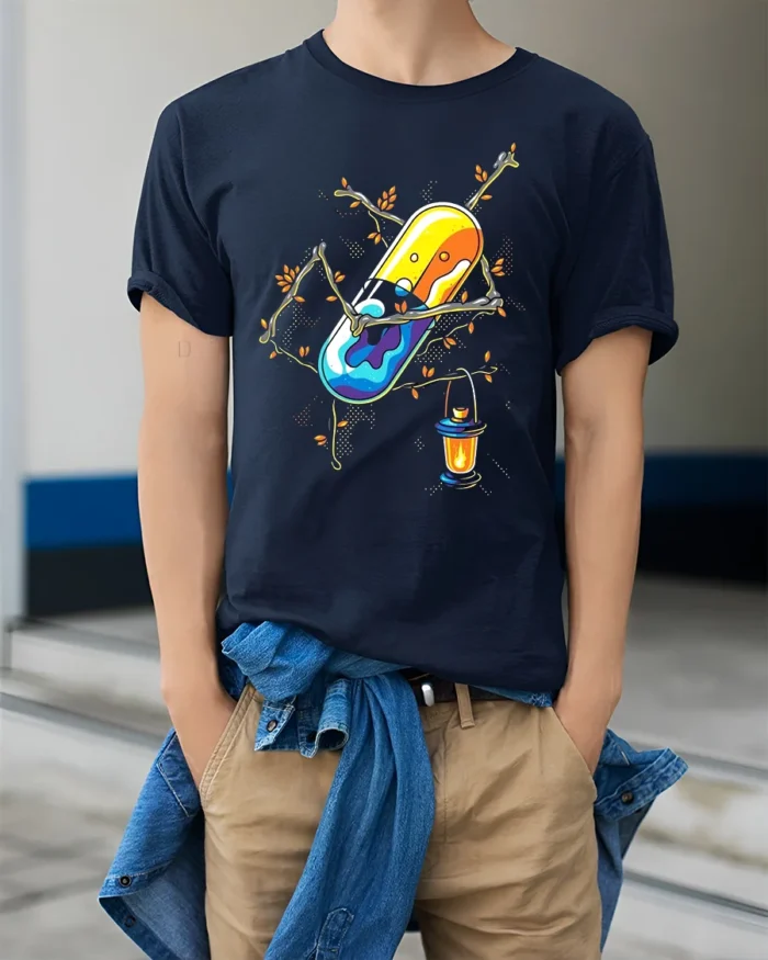 Enchanted Pill T-Shirt Whimsical Capsule Lantern - model wearing navy shirt, hands in pockets