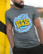 Super Dad Comic Hero Father’s Day T-Shirt - model in grey shirt leaning against column