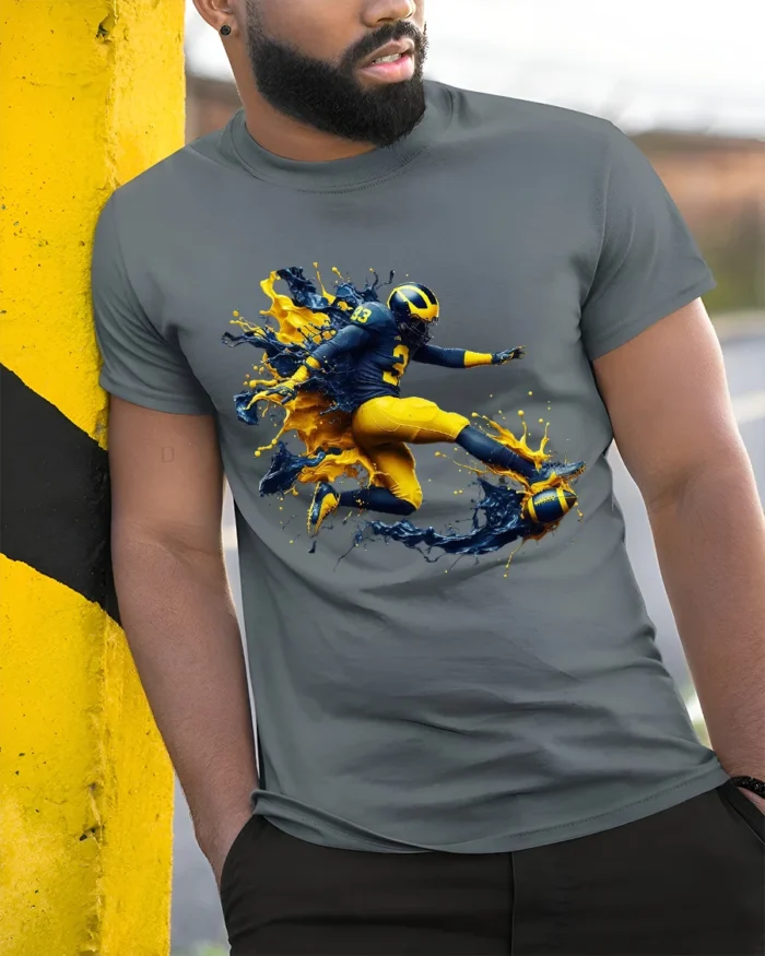 Michigan Wolverines Splash Football Fan T-Shirt - model in grey shirt leaning against column