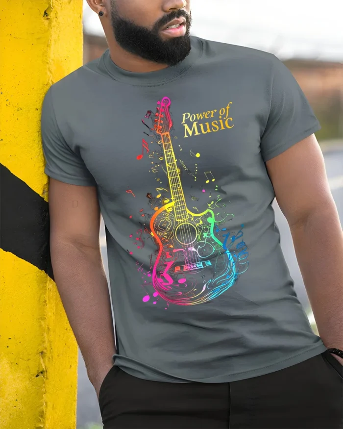 Power of Music Guitar T-shirt with Colorful Notes Art - model in grey shirt leaning against column