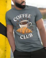 Coffee Club Croissant T-Shirt for Coffee Lovers Foodies - model in grey shirt leaning against column