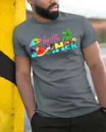 Hello Summer Tropical T-Shirt with Beach and Fruit Design - model in grey shirt leaning against column