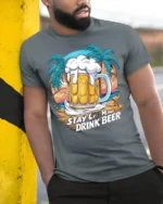 Stay Calm and Drink Beer T-Shirt Funny Beach Bar - model in grey shirt leaning against column