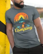 Vintage Camping T-Shirt Tent Fire Forest Mountain Sunset - model in grey shirt leaning against column