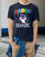 Daddy Shark Birthday T-Shirt for Family Party Fun - model wearing navy shirt, hands in pockets