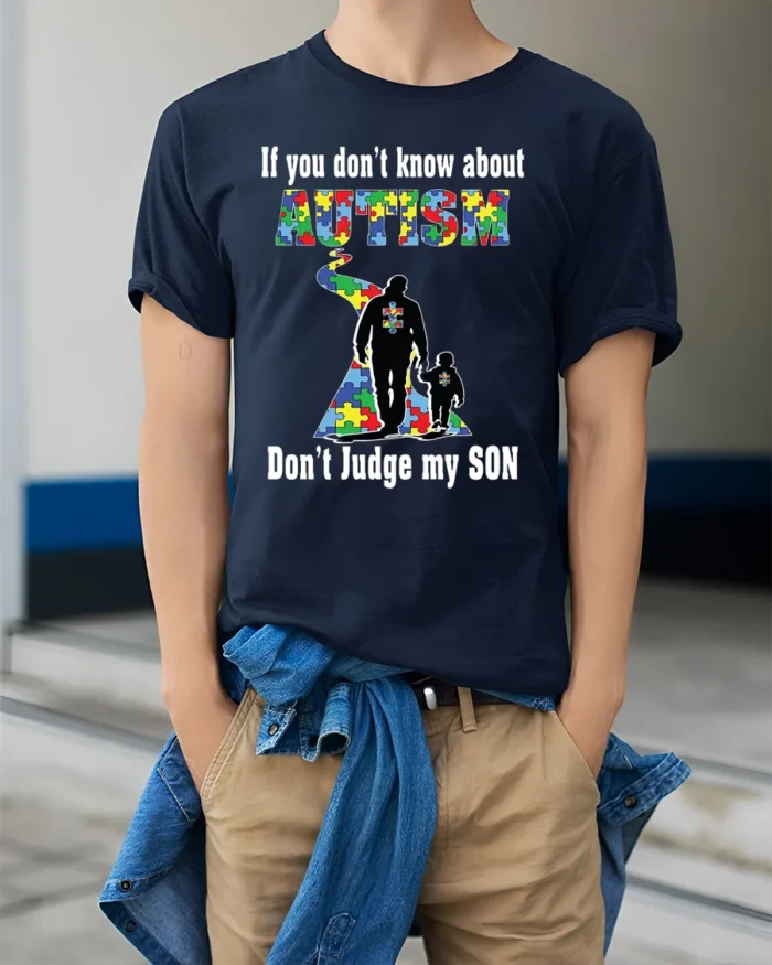 Autism Awareness T-Shirt  Don’t Judge My Son Message - model wearing navy shirt, hands in pockets