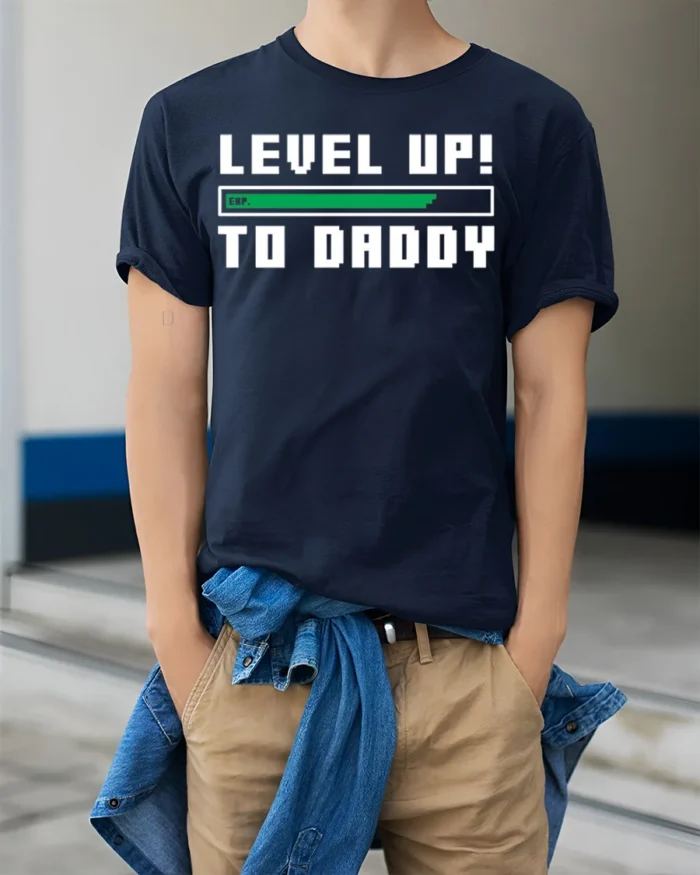 Level Up to Daddy T-Shirt Funny New Dad Gamer - model wearing navy shirt, hands in pockets