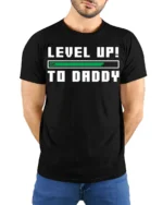 Level Up to Daddy T-Shirt Funny New Dad Gamer - model wearing black shirt, hands behind back
