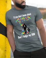Autism Awareness T-Shirt Don’t Judge My Son Message - model in grey shirt leaning against column