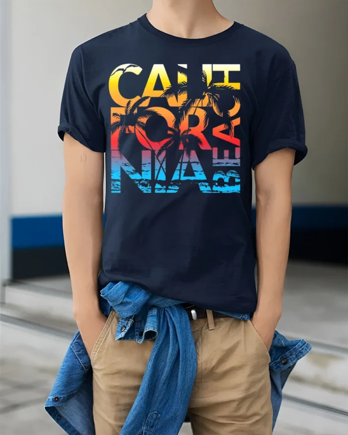 California Beach Sunset T-Shirt with Palm Tree Graphic - model wearing navy shirt, hands in pockets