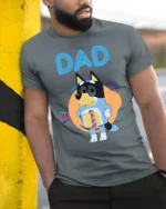 Cute Cartoon Dog Dad T-Shirt for Father’s Day Gift Idea - model in grey shirt leaning against column