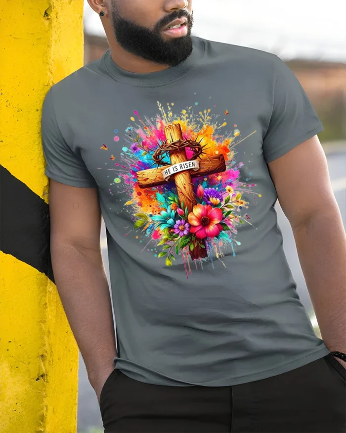 He Is Risen Floral Cross T-Shirt with Color Splash Design - model in grey shirt leaning against column