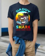 Daddy Shark Doo Doo Funny T-Shirt for Cool Beach Dads - model wearing navy shirt, hands in pockets
