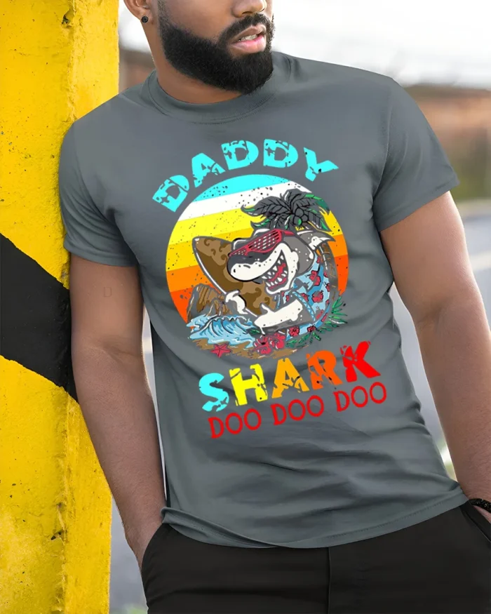 Daddy Shark Doo Doo Funny T-Shirt for Cool Beach Dads - model in grey shirt leaning against column