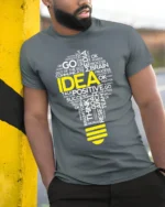 Creative Idea Lightbulb T-Shirt Motivational Graphic - model in grey shirt leaning against column