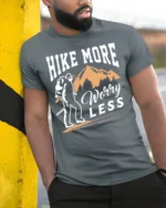 Hike More Worry Less T-Shirt Comfortable Hiking - model in grey shirt leaning against column