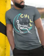 Chill Skeleton Moon T-Shirt Relaxed Cosmic Vibe - model in grey shirt leaning against column
