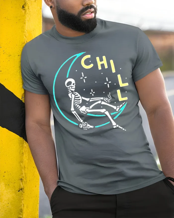 Chill Skeleton Moon T-Shirt Relaxed Cosmic Vibe - model in grey shirt leaning against column