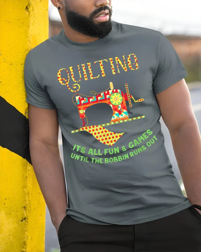 Quilting Fun T-Shirt Funny Bobbin Sewing Machine - model in grey shirt leaning against column