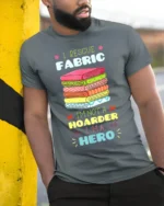 I Rescue Fabric T-Shirt Funny Sewing Hoarder Hero - model in grey shirt leaning against column